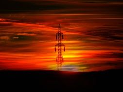 pillar against a bright orange sky at sunset