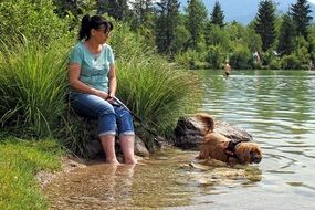 girl with a dog on the lake