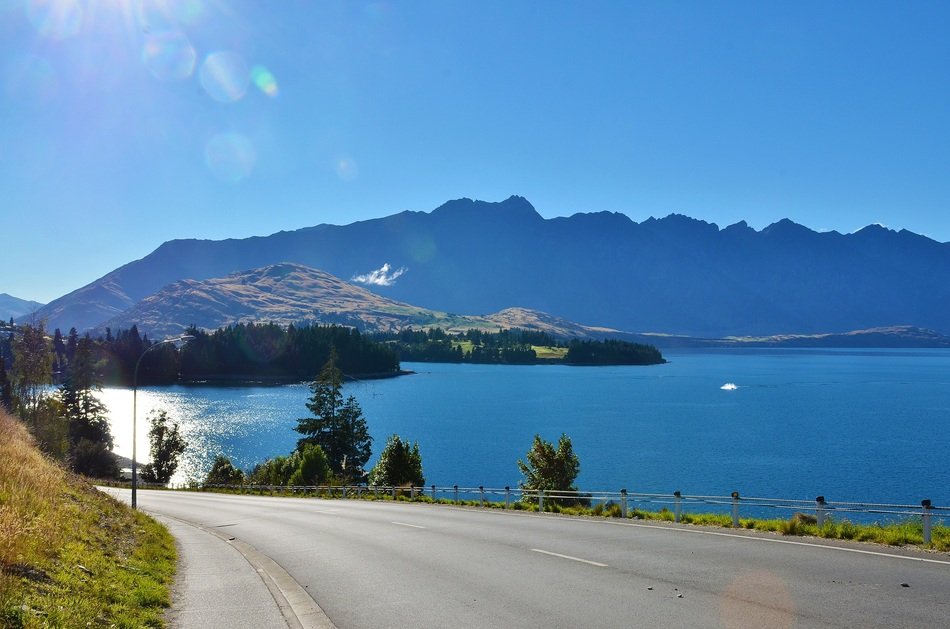 scenery of the blue lake and road on a sunny day