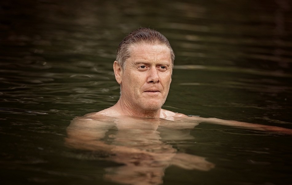 man swimming in the river