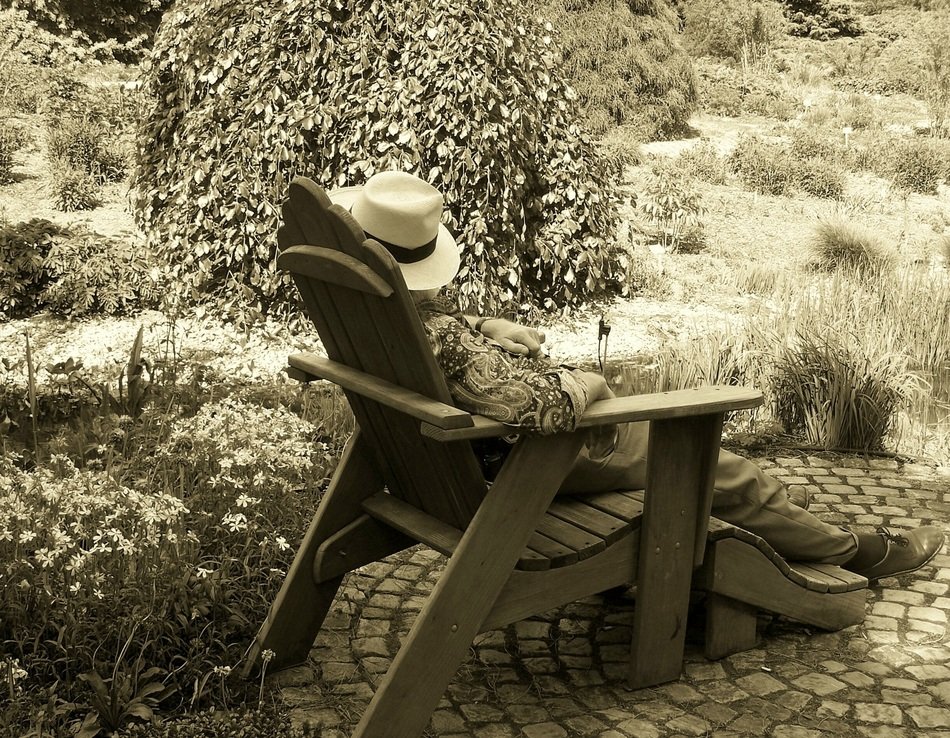 man resting in a chair in the yard