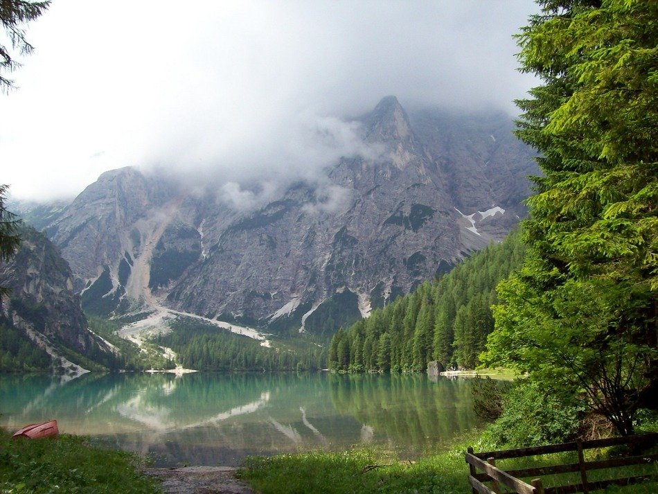 Landscape with the lake near the mountains in spring