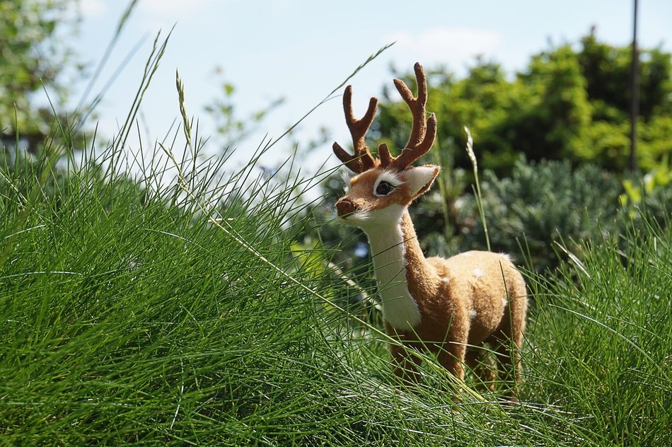 toy deer in the grass