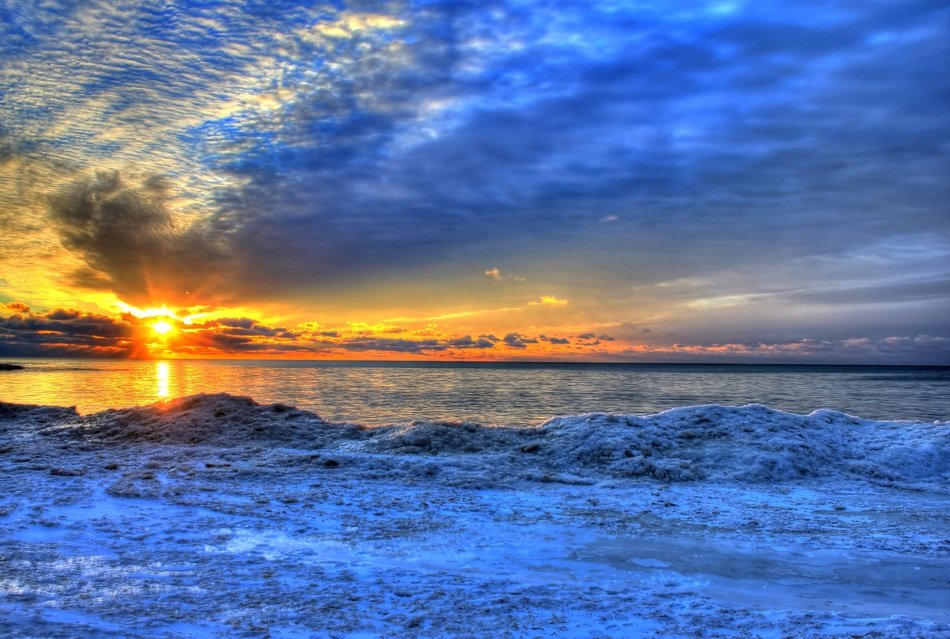 winter landscape of Lake Michigan in the background of a beautiful sunset