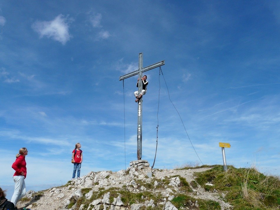 Tourists near the cross at the top of the Alps