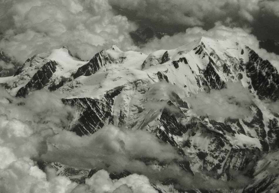 Alps in the clouds in black and white image