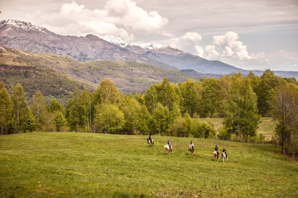 landscape of horse riders in mountains of Italy