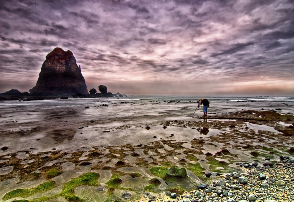 photographer taking a picture of a beach