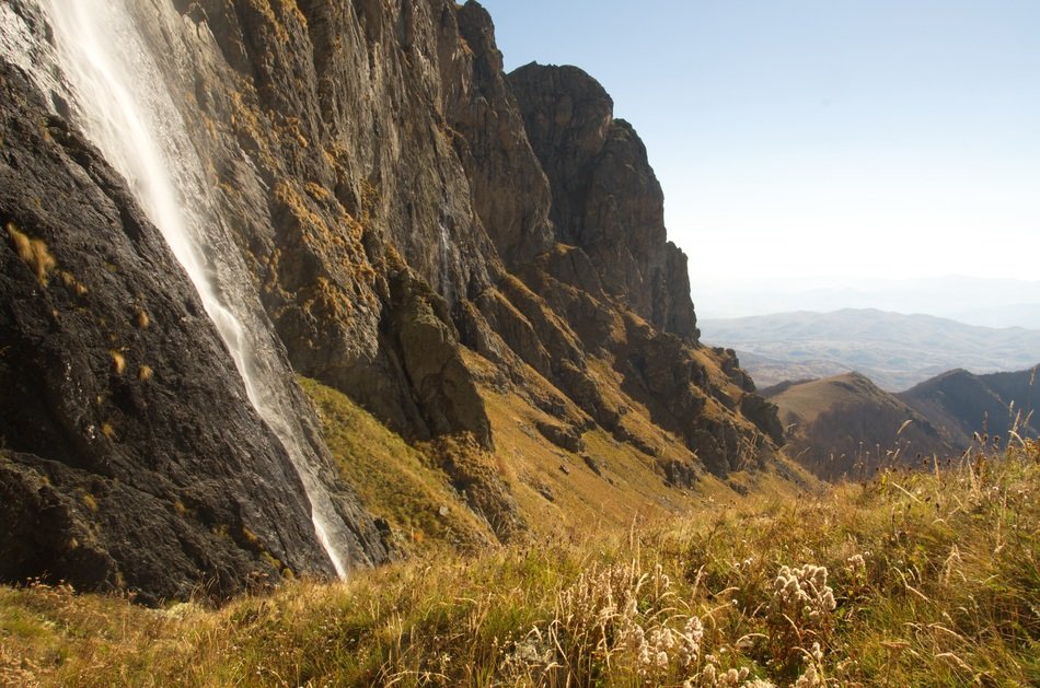 waterfall on a cliff among beautiful nature