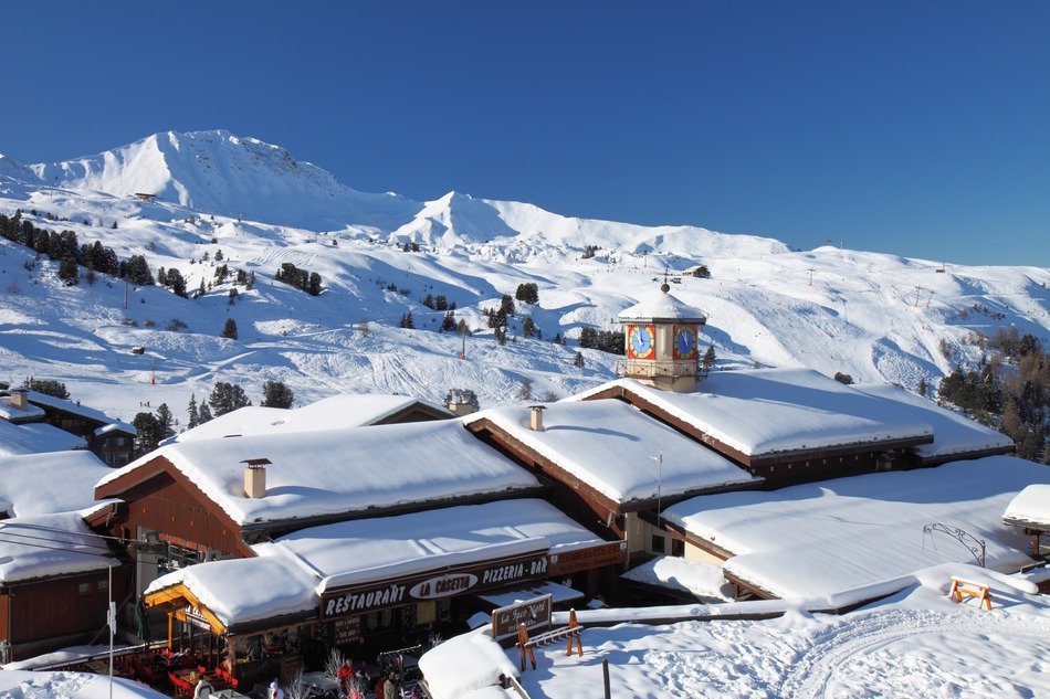 snow on the roofs of houses in the Alps