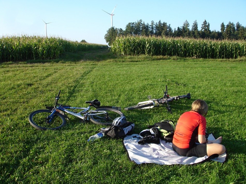 cyclist is resting in the meadow