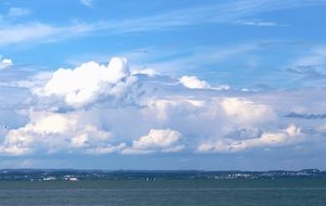 white cumulus clouds over the ocean