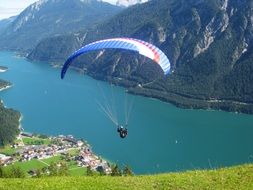 summer landscape with paraglider, flying above mountain lake