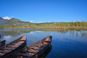 parked boats on water and white cloud on a blue sky