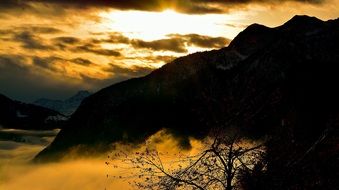 yellow sunrise over the mountains in the haze