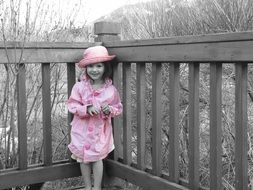 child in pink in a world of gray