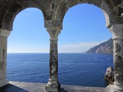 virw of blue sea whrough marble columnar, italy, liguria