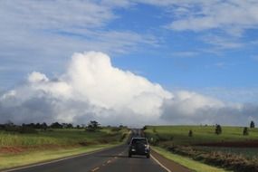 black jeep rides on an asphalt road in the countryside