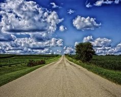 cloudy sky over a road in the countryside