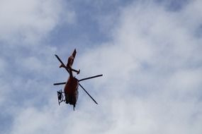 mountain rescue helicopter in the blue sky