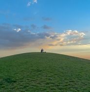 green hill at summer evening