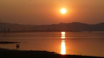 Red sun at sunset over the river