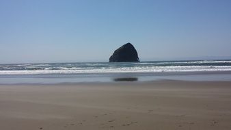 huge rock in the ocean off the coast