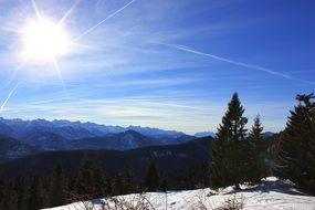 bright sun over snow-capped mountains