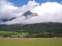 scenic countryside and fluffy white clouds at mountain, austria