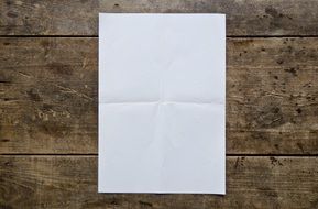 Blank poster on the wooden table