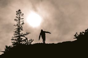 Silhouette of a man on a mountain at sunset