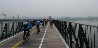 people cycling on bridge above water, south korea