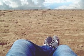 legs rest mirroring sand