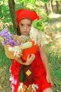 portrait of cute girl in red in forest