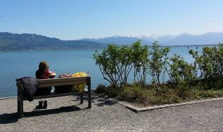 woman on a bench on the shore of Lake Constance