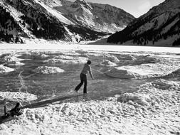 woman on a frozen lake in the mountains