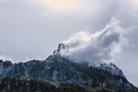 mountain peak covered by the white cloud