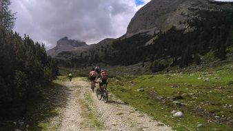 Humans riding on a bikes on a mountain roads