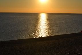 orange evening sun reflected in water