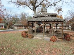 wooden vintage gazebo in autumn park