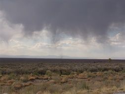 rain clouds over the field