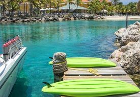 The lagoon at the resort with green Kayak boats