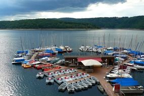 landscape of amazing lake pier and sailing boats