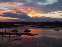 sunset on the background of boats in the ocean