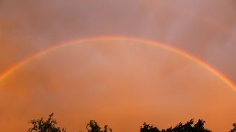 double rainbow against the sky at sunset