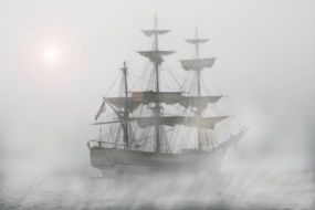 Pirate ship at sea in the fog