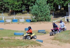 children riding go-karts on track