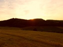 orange sunset over evening field