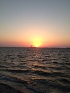 sailing ship in the ocean at sunset