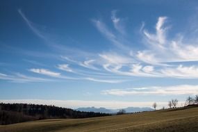 cirrus clouds above mountains landscape